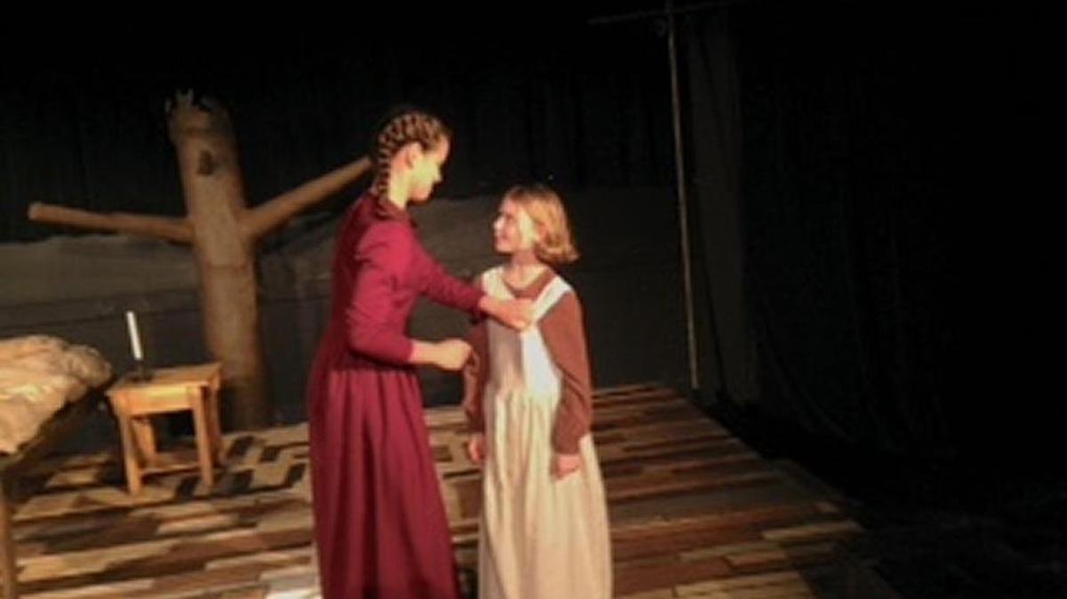 Deva Holliman (in red) and Annalena Mecagni as Betty Paris in ‘The Crucible.’