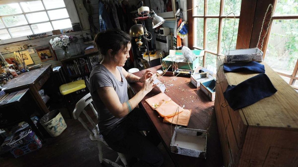 Artist Catherine Edgerton is working on stained-glass kaleidoscopes in her home studio for her upcoming exhibit "Bottled Light" exploring mental health through books, drawings, and stained-glass kaleidoscopes.