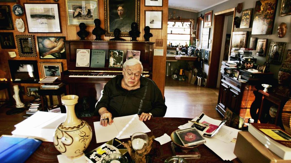 Writer Reynolds Price looks over a memoir of his life at his Durham home in 2008. Price’s house and collections are the subject of the book, “Dream of a House,” by photographer Alex Harris.
