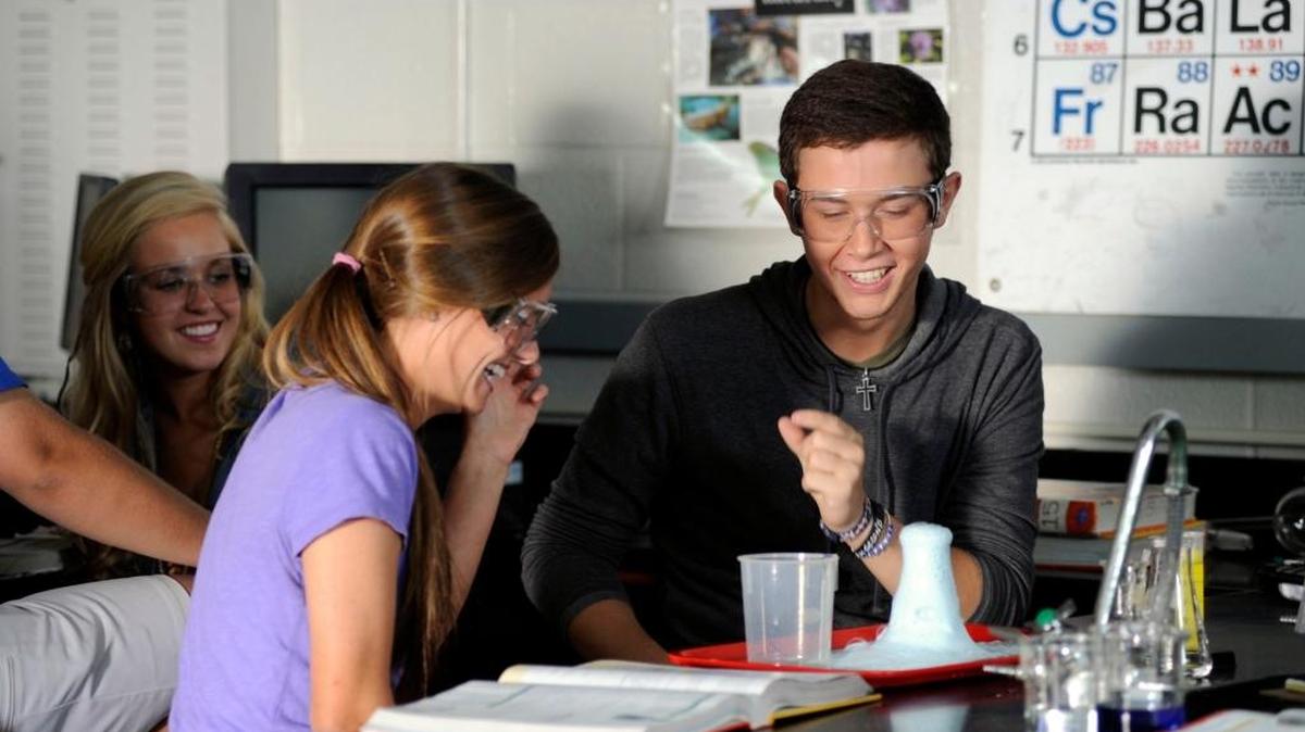 American Idol winner Scotty McCreery, right, jokes with his friends Ava Taylor-Mumford, left, and Gabi Dugal, center, while filming a scene in his music video for the new song "The Trouble with Girls" Saturday October 1, 2011 at Garner High School.