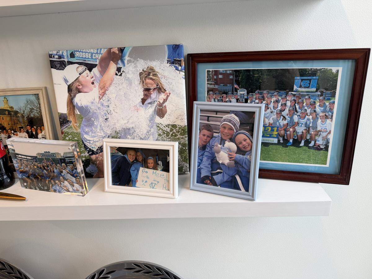 Photos of her players and kids line UNC women's lacrosse coach Jenny Levy’s office in Chapel Hill.