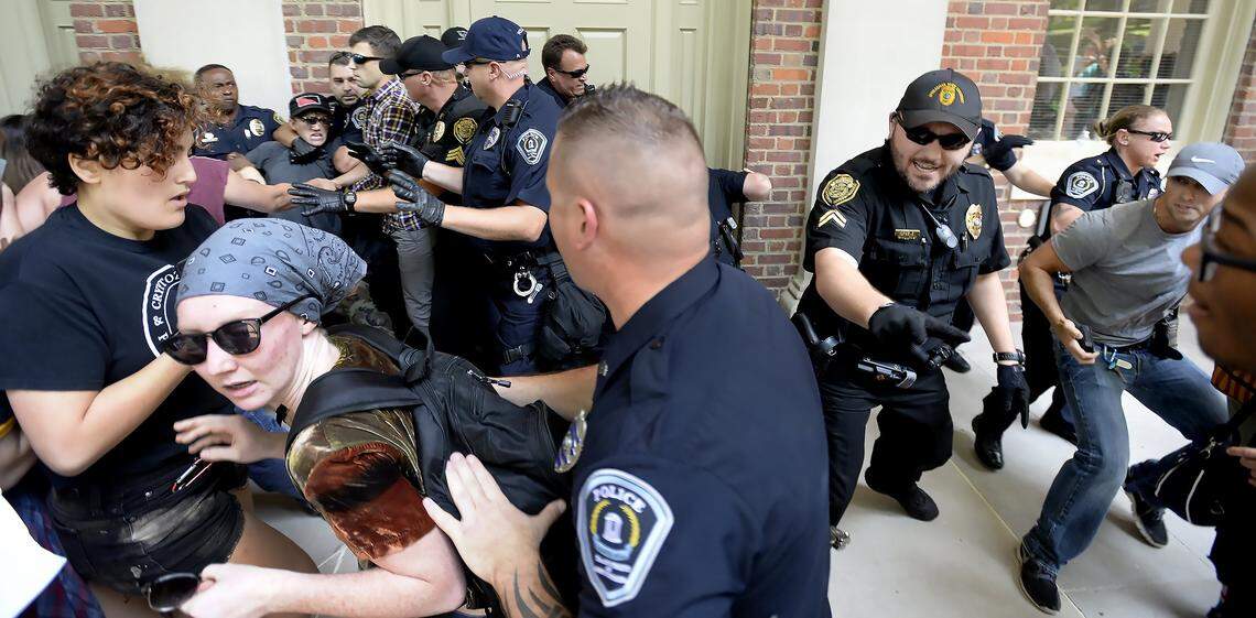 UNC and Chapel Hill police scuffle with protesters they are attempting to arrest during a rally in front of Graham Memorial Building on the campus of UNC in Chapel Hill, N.C., Saturday, August 25, 2018. The rally featured those for and against the removal of the controversial Silent Sam statue which was toppled earlier this week.