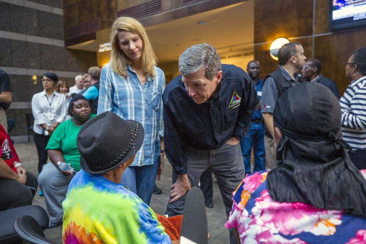 NC Governor Roy Cooper and First Lady Kristin Cooper greet people seeking refuge from Hurricane Florence at a recently-opened shelter operated by the American Red Cross in the Friday Center at UNC-Chapel Hill on Sunday, Sept. 16, 2018, in Chapel Hill, NC. Many of the residents are members of the Congolese refugee community in New Bern, NC, which received a mandatory evacuation order.