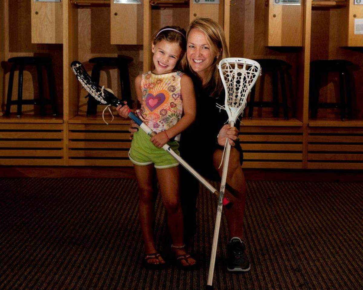 A young Kate Levy and her mother, UNC women’s lacrosse head coach Jenny Levy, pose with lacrosse sticks. “I know she wants me to be the best I can be,” Kate said of her mom. “It’s easy to take feedback from her, and she’s proof that she knows what she’s doing.”