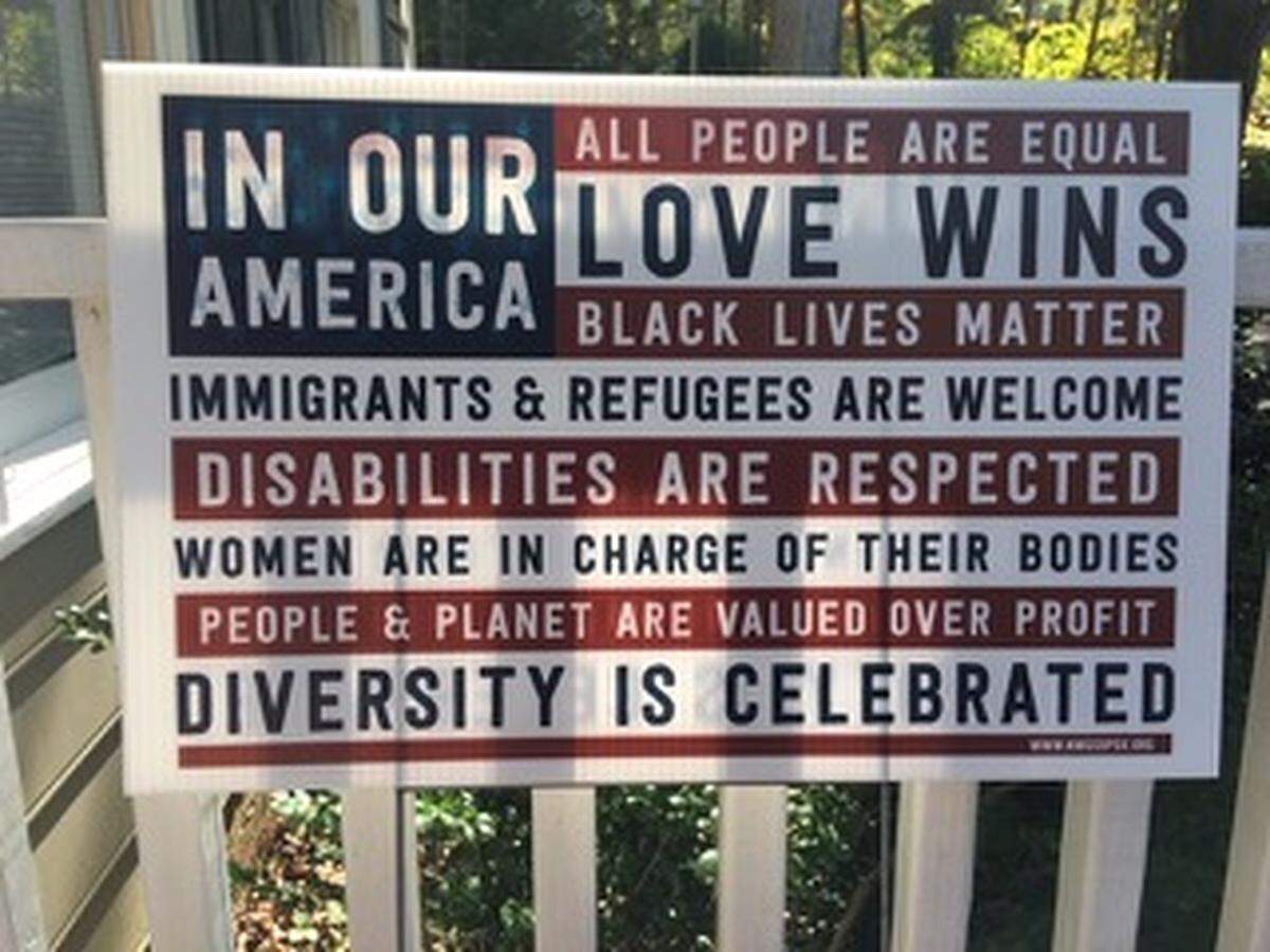 Sarah Bickley’s “In Our America” sign, which she had in her yard in Woodcroft in South Durham until the homeowners association told her to take it down.