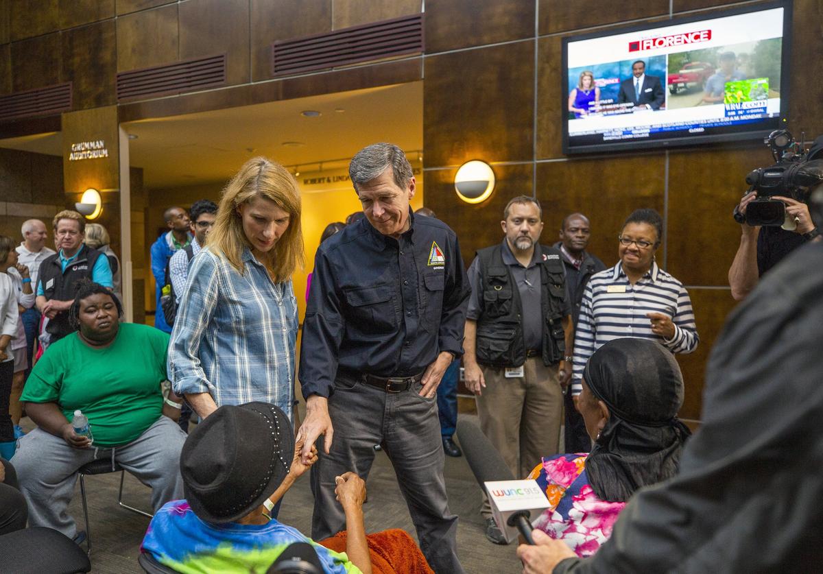 NC Governor Roy Cooper and First Lady Kristin Cooper greet people seeking refuge from Hurricane Florence at a recently-opened shelter operated by the American Red Cross in the Friday Center at UNC-Chapel Hill on Sunday, Sept. 16, 2018, in Chapel Hill, NC. Many of the residents are members of the Congolese refugee community in New Bern, NC, which received a mandatory evacuation order.