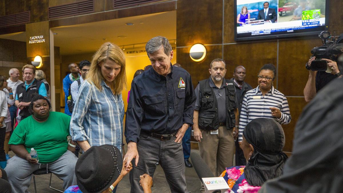 NC Governor Roy Cooper and First Lady Kristin Cooper greet people seeking refuge from Hurricane Florence at a recently-opened shelter operated by the American Red Cross in the Friday Center at UNC-Chapel Hill on Sunday, Sept. 16, 2018, in Chapel Hill, NC. Many of the residents are members of the Congolese refugee community in New Bern, NC, which received a mandatory evacuation order.