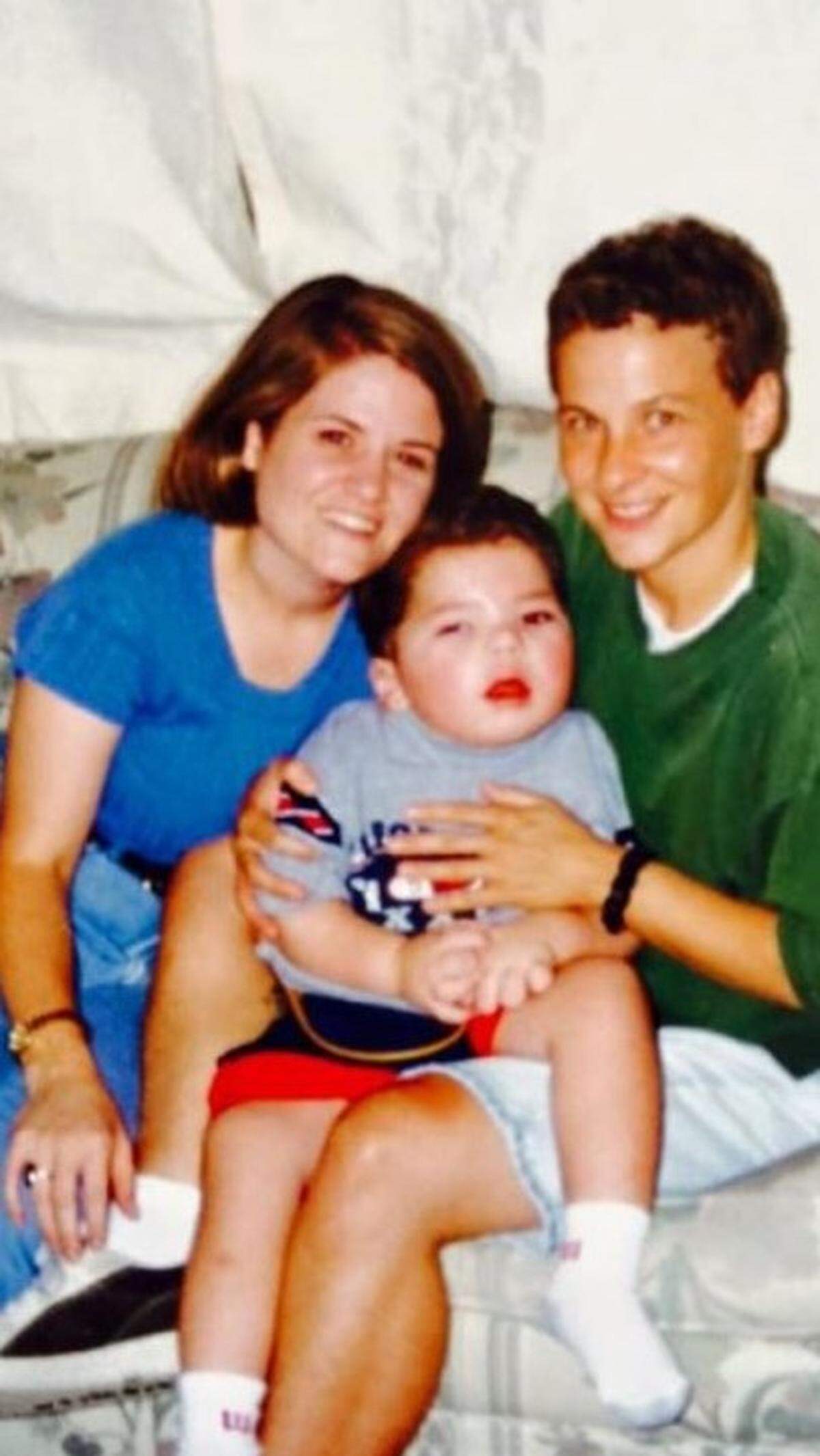 Beth Schmitt, left, David Stuart, and Lori Stuart in a photograph taken soon after they adopted David in 1999.