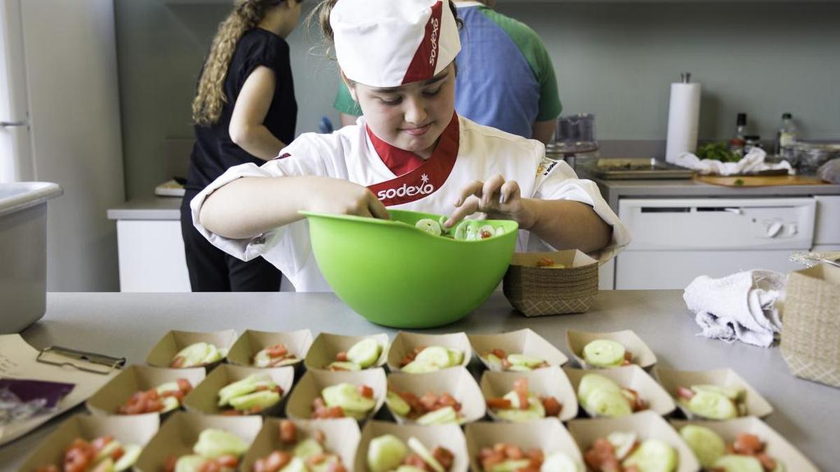 Karaleigh Schmidt divvies up servings of local vegetables she prepared at the Farm to Fork Youth Camp cooking competition.