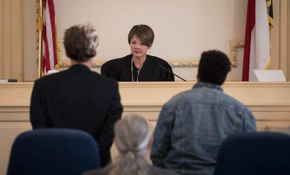 Orange County District Court Judge, Samantha Cabe, center, hands down a guilty verdict to Maya Little, right, and her attorney Scott Holmes, left, on Monday, Oct. 15, 2018.
