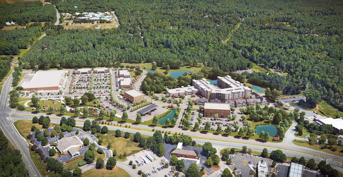 This drawing shows the planned Lloyd Farm development at N.C. 54 and Old Fayetteville Road in Carrboro. A Harris Teeter grocery store anchors the left side of the development. Up to 220 senior-living apartments, cottages and duplexes are at right, next to the Carrboro Post Office. Carrboro Plaza is shown at the bottom, and McDougle Middle School is at the top left.