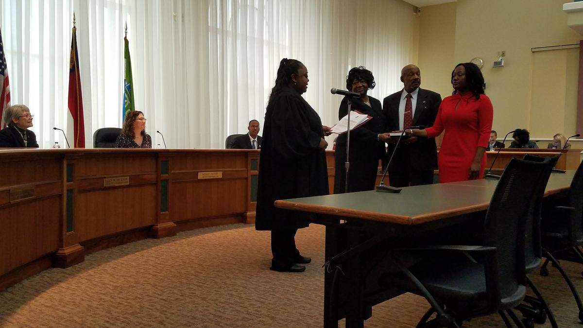 Natalie Murdock, in red, was sworn in as a Durham County Soil and Water Conservation Distrist supervisor on Monday, Dec. 3, 2018. David Harris was also sworn in as a supervisor. They were elected in November.