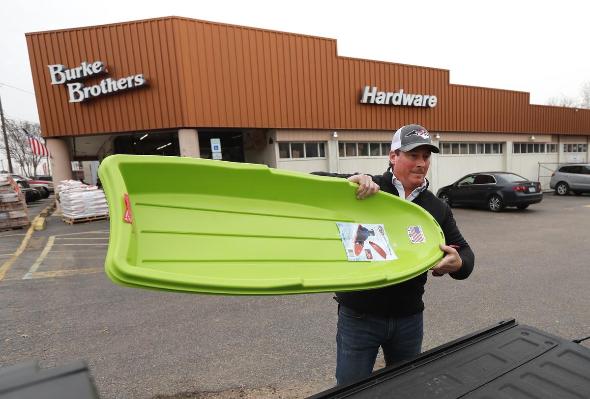 Josh Johnson of Raleigh places sleds on his truck after purchasing them at Burke Brothers Hardware in Raleigh, N.C., Saturday, Dec. 8, 2018.
