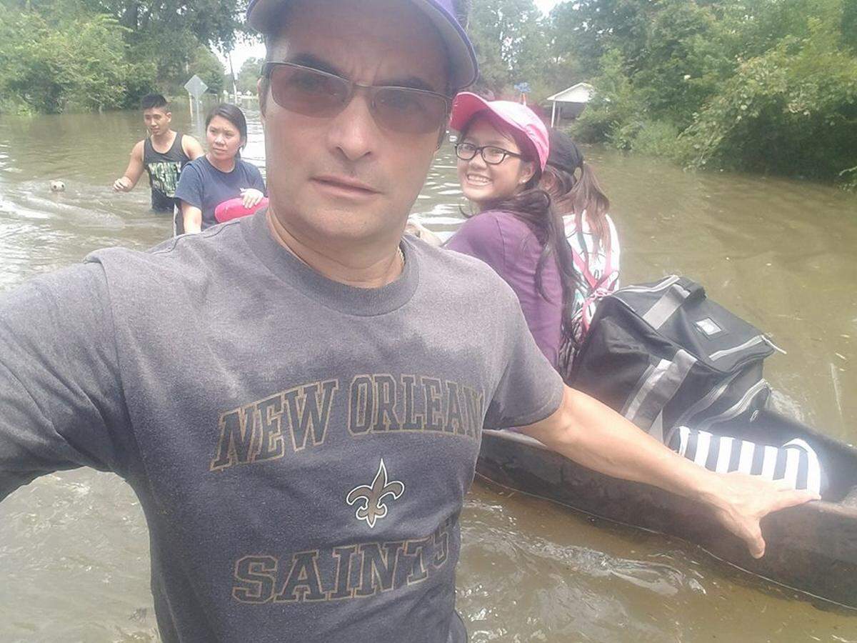 Todd Terrell, founder of the United Cajun Navy, pulling family to safety in a pirogue during the 2016 1,000 year flood in Baton Rouge.  The United Cajun Navy and other sects of the Cajun Navy have descended on the Carolinas to help before, during and after the Hurricane Florence.