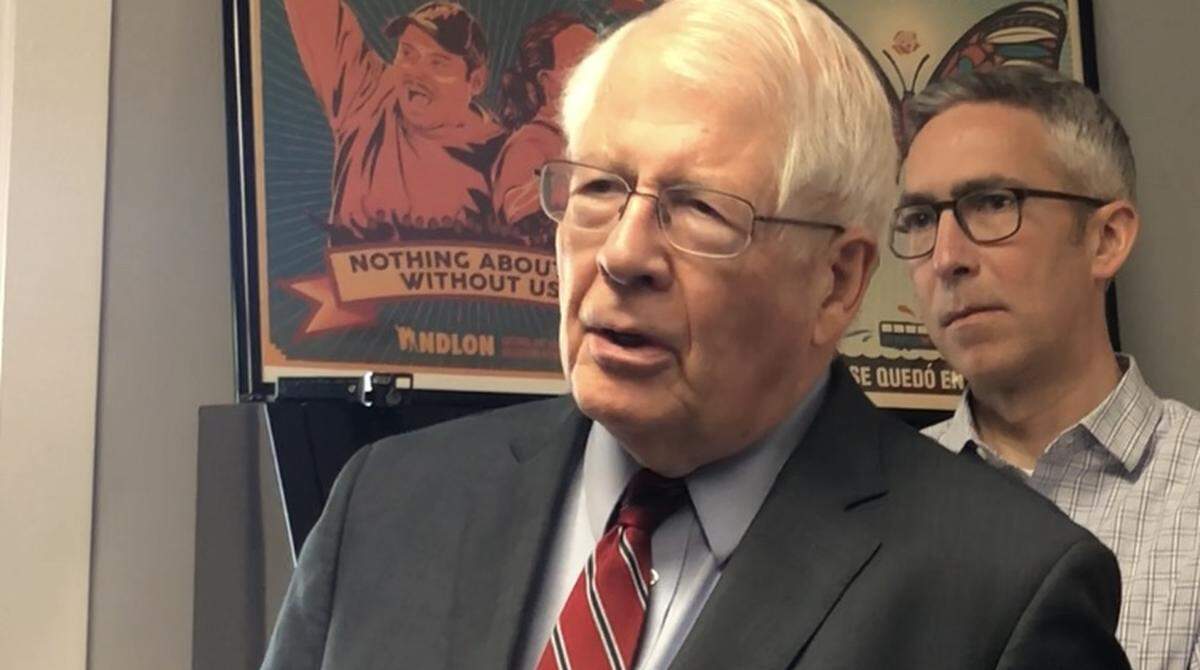 U.S. Rep. David Price (D-NC) criticizes recent immigration raids during a visit to El Centro Hispano on Friday, April 20, 2018, as Carrboro Alderman Damon Seils listens.