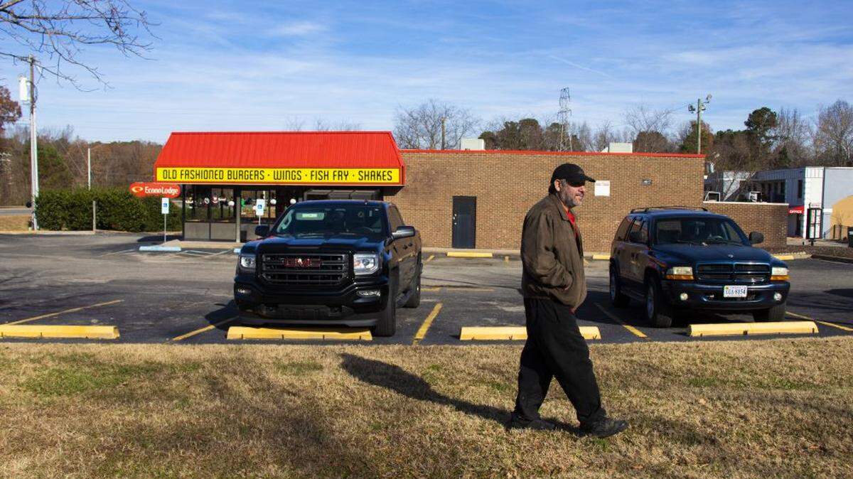 Jose Gomez has to walk in the grass beside a busy highway in southern Durham on his morning commute to work because there are no sidewalks.