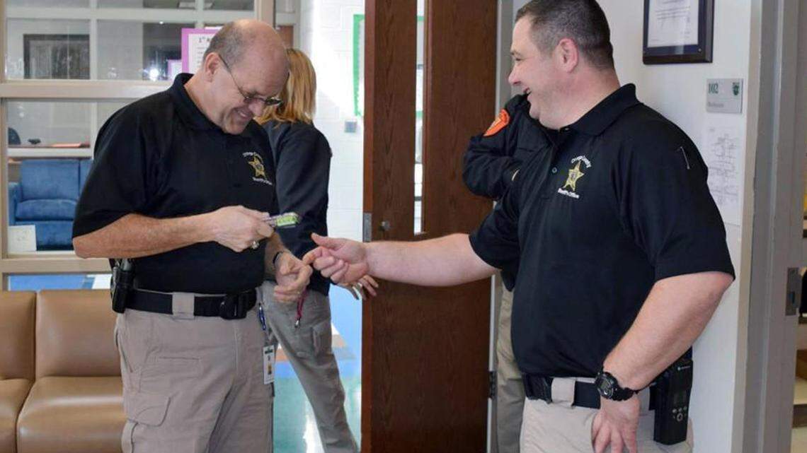 Chief Deputy Jamison Sykes jokes around with Sheriff Charles Blackwood on March 3, 2016, while visiting the county’s schools.