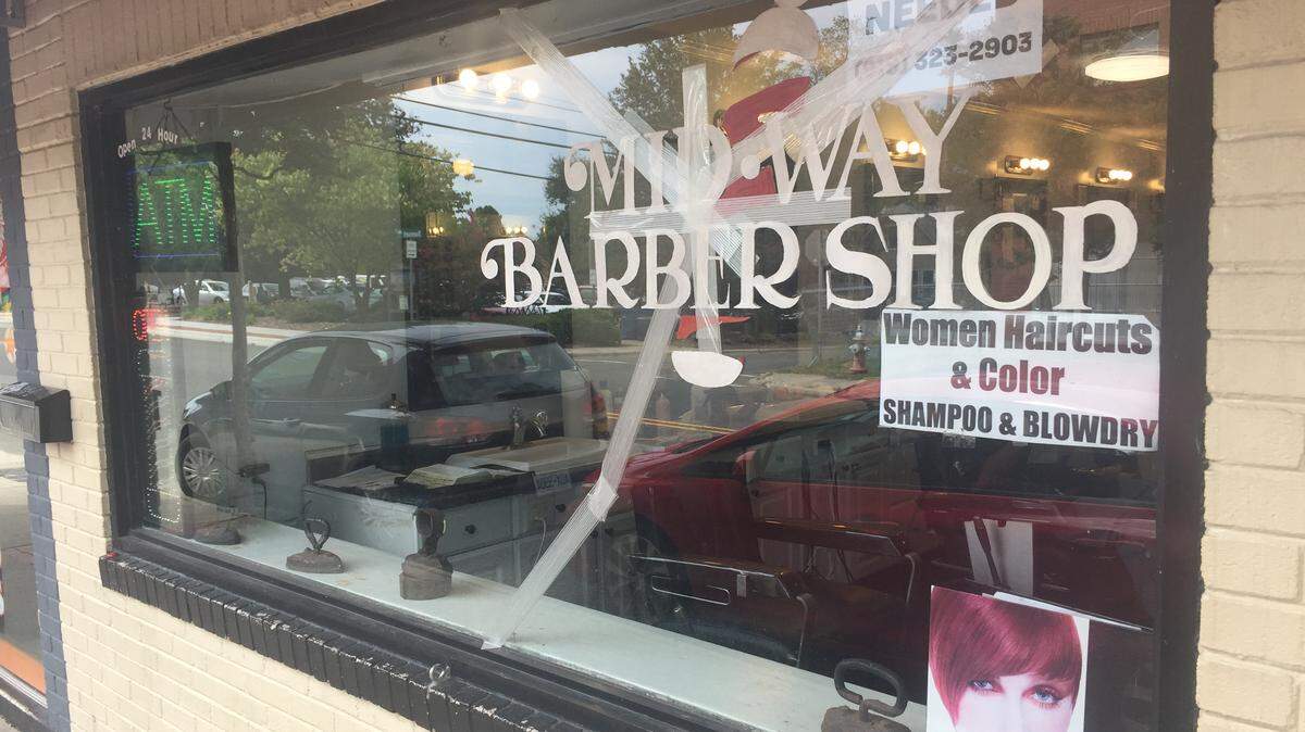 The front window of the Midway Barber Shop in Carrboro is taped after it was damaged earlier this week.