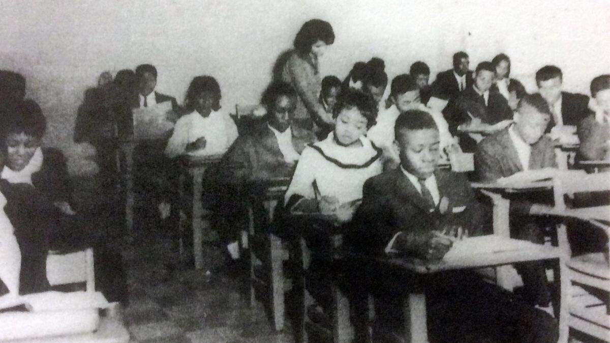 Teacher Ms. D.P. Simpson works with students in her social studies class at the all-black Central High School in Hillsborough. The school was integrated with the all-white Orange High School in 1968.