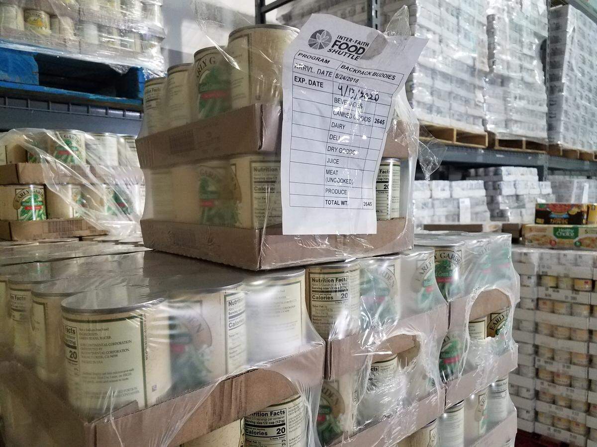 Cans of vegetables stacked in the 7,000 square-foot warehouse in Durham that is the Inter-Faith Food Shuttle’s new Child Food Hub.