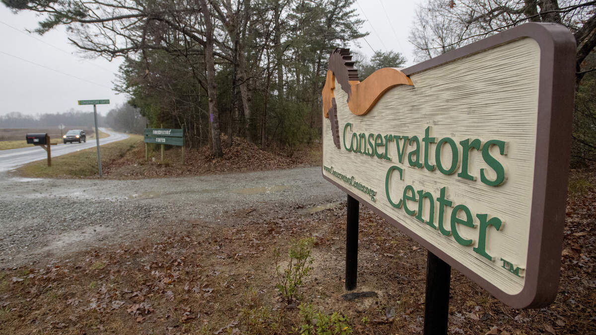 FILE - This Dec. 31, 2018 file photo shows a sign of Conservators’ Center at the property near Burlington, N.C. A sheriff’s report said it took three tranquilizer darts and eight gunshots to subdue a lion that fatally attacked a zoo intern at the center on Sunday, Dec. 30. The lion killed 22-year-old intern Alexandra Black as she helped staff members clean an animal enclosure. (Woody Marshall/The Times-News via AP, file)