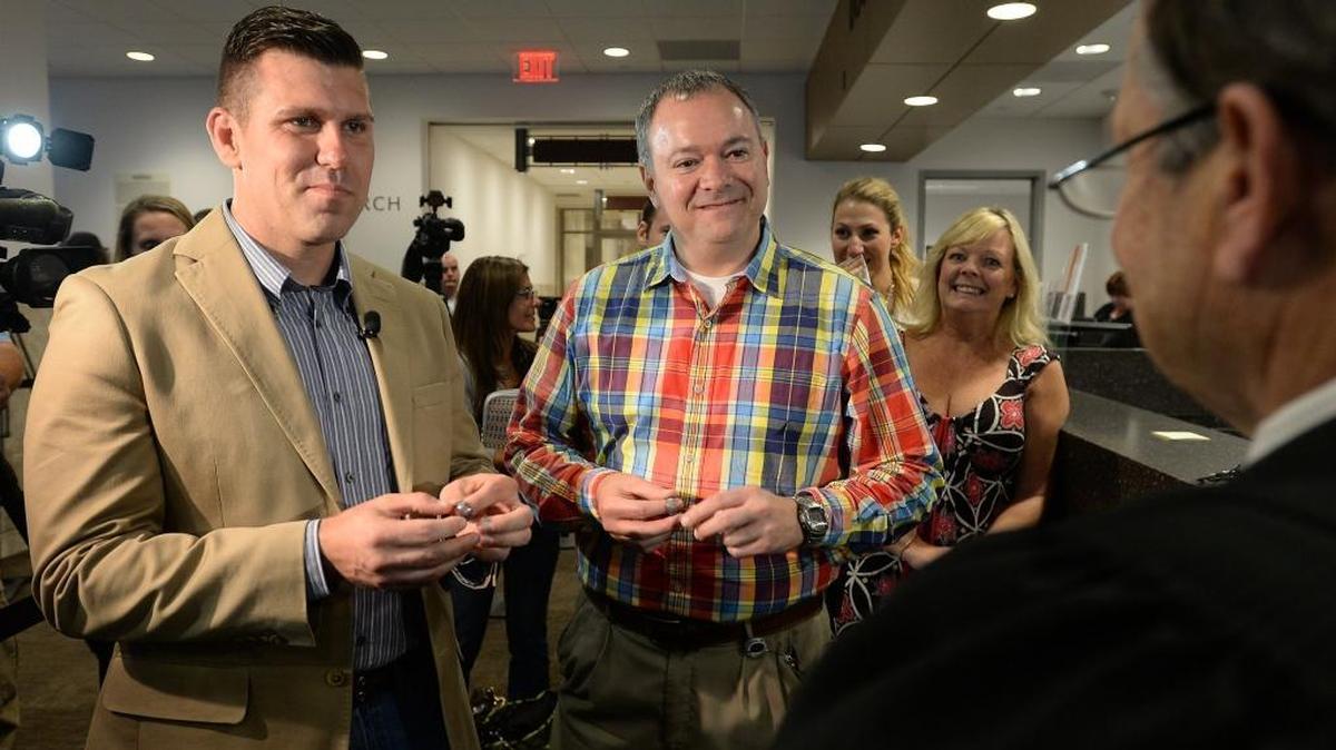 Chad Biggs (left) and his fiance, Chris Creech say their wedding vows in front of Wake County magistrate Dexter Williams at the Wake County Courthouse in Raleigh, N.C. Friday, October 10, 2014.