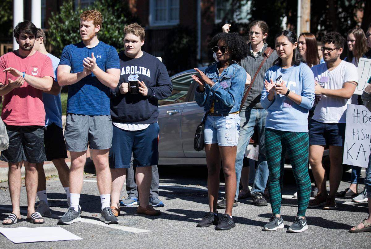 Some members of the Pi Kappa Alpha joined the crowd of demonstrators for the #BelieveSurvivors rally that ended up in the parking lot of UNC’s fraternity court on Friday, Oct. 12, 2018. Survivors of sexual assault told stories and encouraged people to participate in changing rape culture on UNC’s campus.