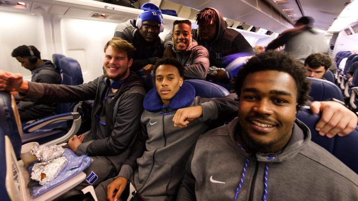 Duke University football players (front row) Robert Kraeling, Myles Hudzick and Jaylen Miller join (second row) Derrick Tangelo, Antone Williams and Axel Nyembwe on the team's flight to New York last November to play Army. The athletics staff at Duke uses a software package called Teamworks to, among other things, assign players seats on airplanes when the team travels. Former Duke player Zach Maurides developed the software and heads the company behind it.