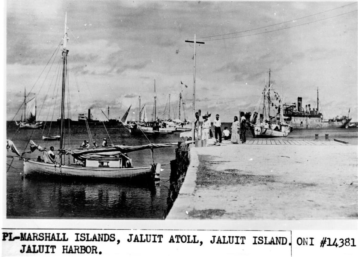A History channel documentary uses this undated photo of people on a dock on Jaluit Atoll in the Marshall Islands to conclude that aviator Amelia Earhart, seated third from right, survived a 1937 crash. One problem: A Japanese military history blogger unearthed evidence that the photo was first published in a 1935 Japanese travelogue.