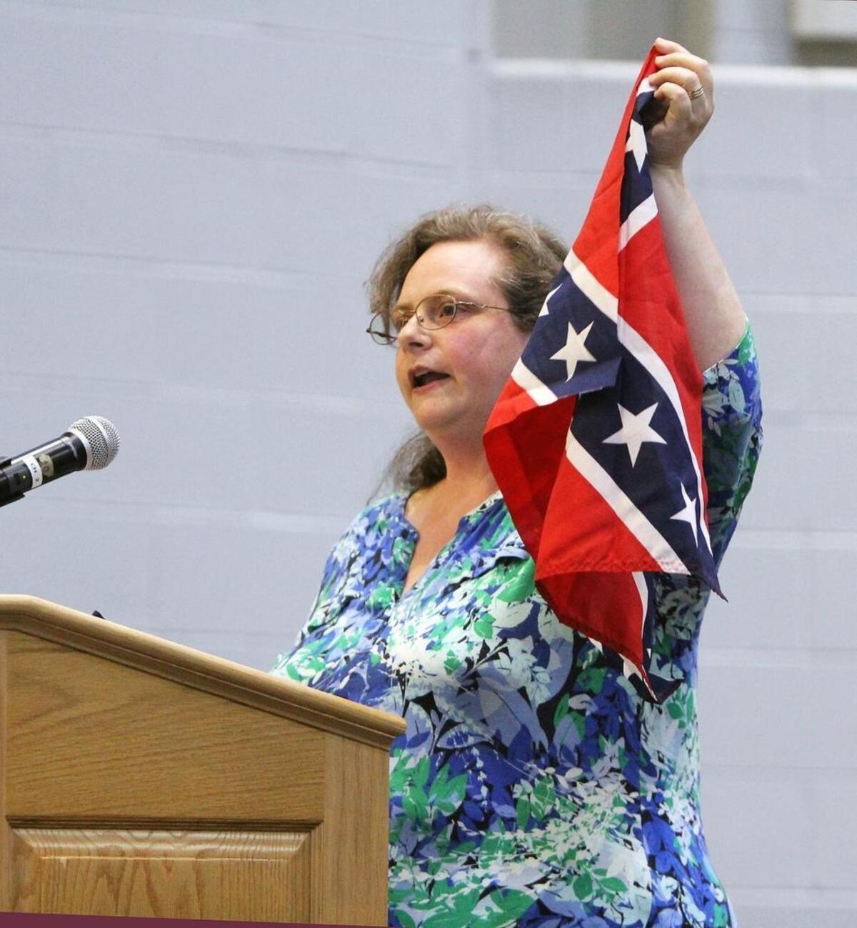 "Historical context and use of the symbol as harbinger of violence and murder is at issue here," Hillsborough resident Katherine Walker tells the Orange County Schools Board of Education Monday, April 24, 2017, at Stanback Middle School in Hillsborough, NC. She and about two dozen speakers urged the board to ban the flag on school system property.