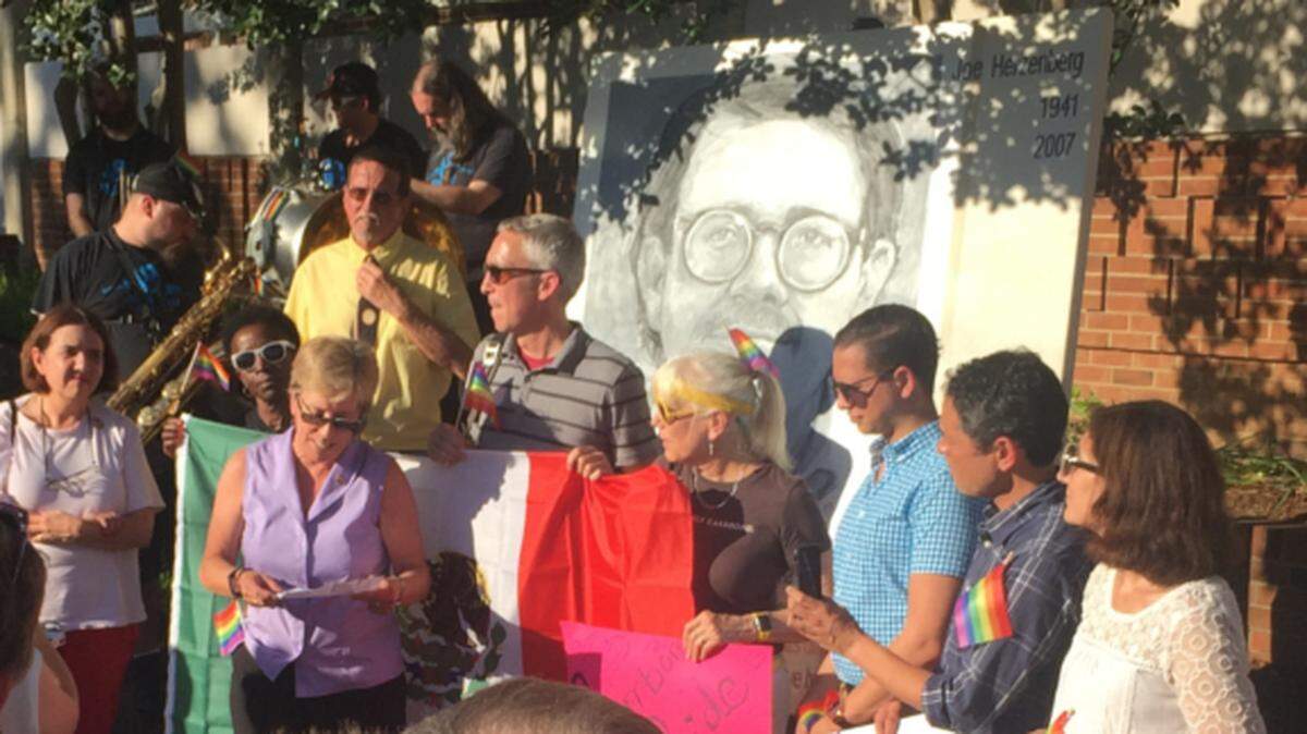 Carrboro Mayor Lydia Lavelle reads a proclamation at the unveiling of a portrait of former Chapel Hill Town Councilman Joe Herzenberg at the Carrboro Century Center Tuesday.