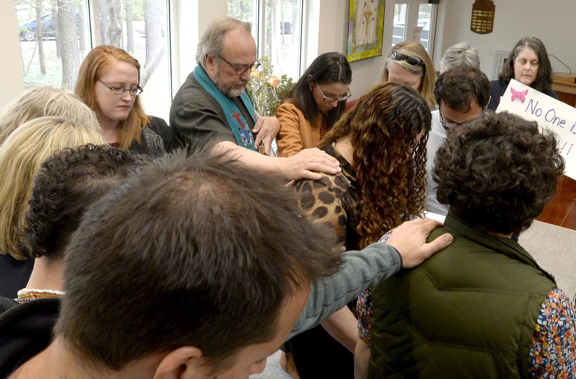 Immigration advocates and clergy hold a prayer circle for Rosa del Carmen Ortez-Cruz, a Greensboro immigrant with deportation orders to Honduras. Ortiz-Cruz has taken sanctuary in the Church of Reconciliation in Chapel Hill, N.C. Church officials and immigration advocates held a press conference to talk about recent ICE raids and plans for a North Carolina Sanctuary Coalition in Chapel Hill, N.C. Tuesday, April 17, 2018.