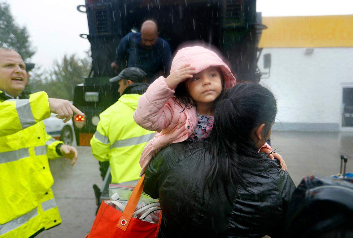 Joanna Faulkner carries her daughter Kayla, 3, out of a high water vehicle after being evacuated by the police when her neighborhood began to flood as Florence continues to dump heavy rain in Fayetteville, N.C., Sunday, Sept. 16, 2018. 
