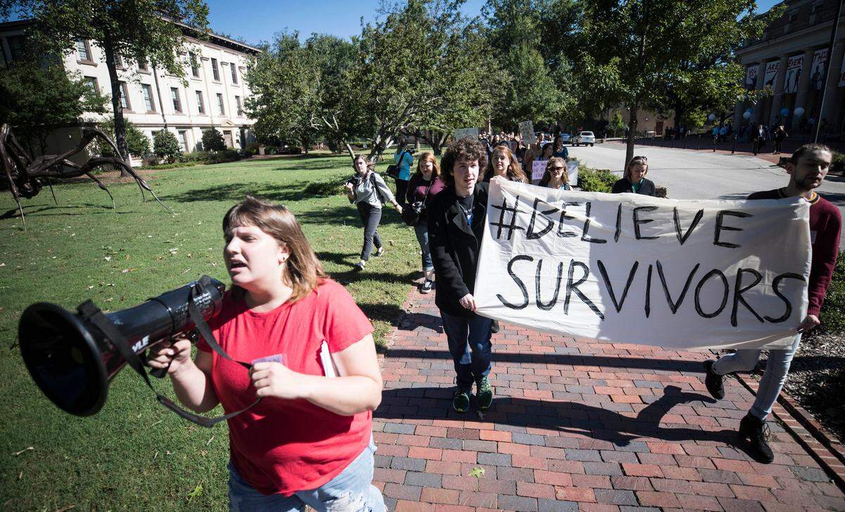 Hannah Inman, an organizer of the #BelieveSurvivors rally, leads a march to fraternity court after speakers told their stories and expressed frustration at UNC’s response to sexual assault on campus in front of South Building on Friday, Oct. 12, 2018.