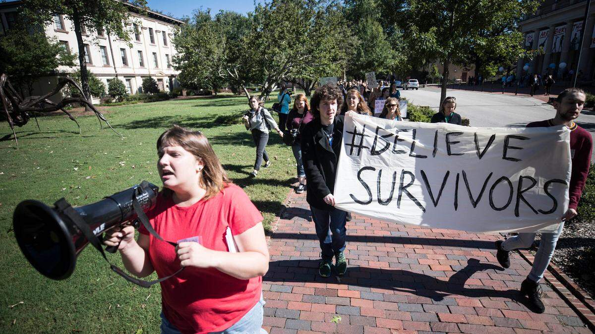 Hannah Inman, an organizer of the #BelieveSurvivors rally, leads a march to fraternity court after speakers told their stories and expressed frustration at UNC’s response to sexual assault on campus in front of South Building on Friday, Oct. 12, 2018.