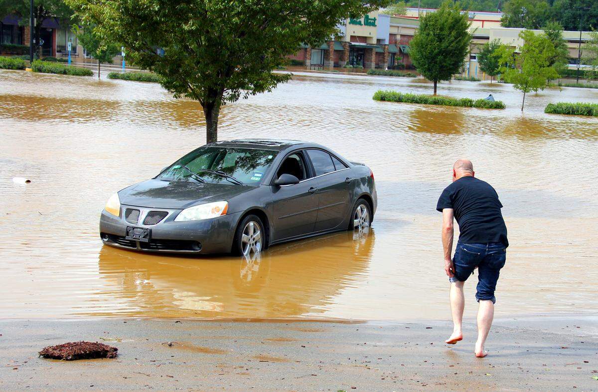 Steve Hammer, 40, of Carrboro, just bought his Pontiac G6 two months ago. Water reached the door handles before it began subsiding Monday morning at Eastgate Crossing in Chapel Hill.