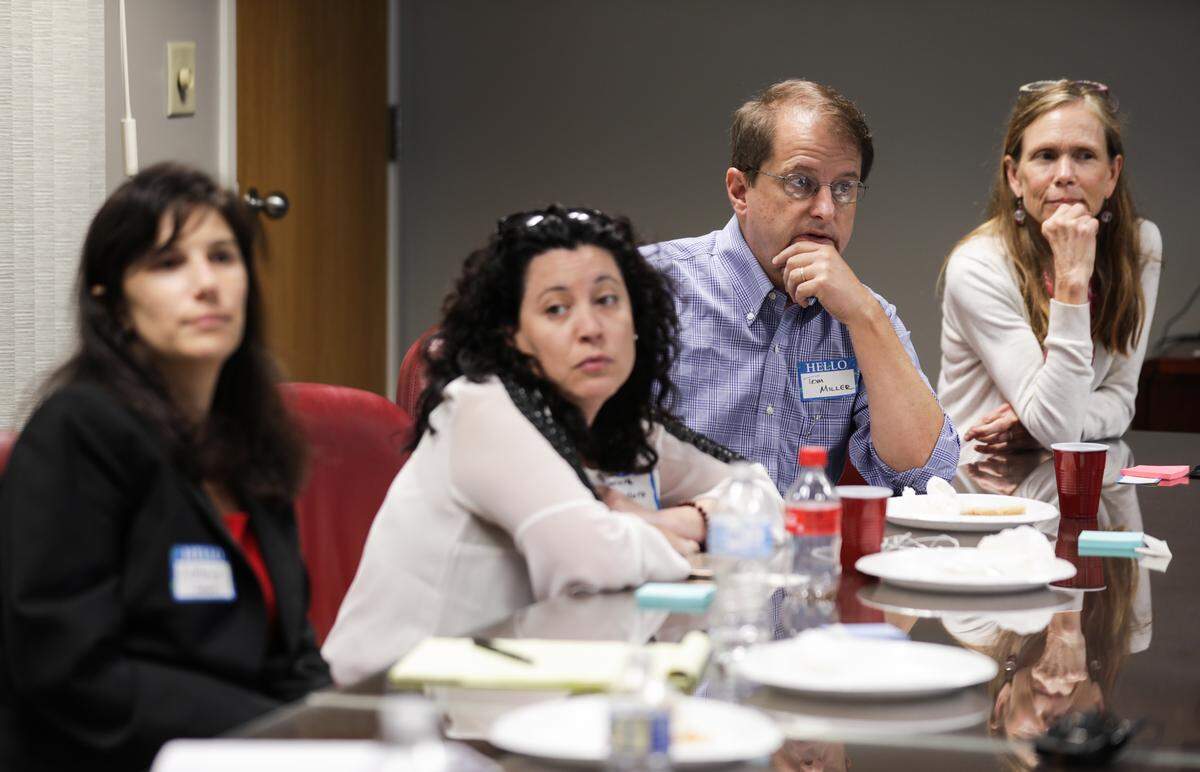 From left to right, Kathryn Sabbeth, associate professor at UNC School of Law, Javiera Caballero, Durham City Council member, Tom Miller, Durham Planning Commissioner and retired attorney, and Heidi Carter, Durham County Commissioner, listen to a panelist speak about issues surrounding gentrification in Durham at the Herald-Sun office on Tuesday, August 28, 2018.
