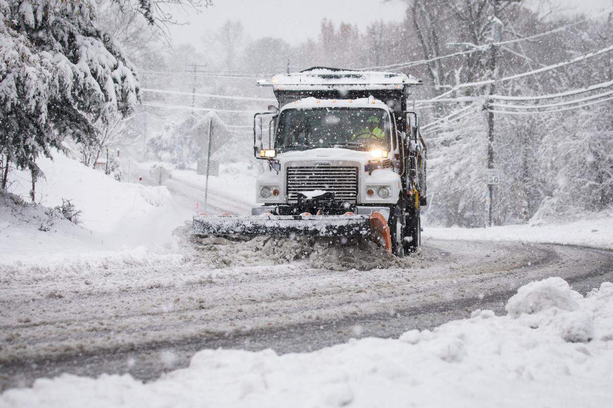 A snow plow drives up N. Greensboro Street in Carrboro, NC on Sunday, Dec. 9, 2018.