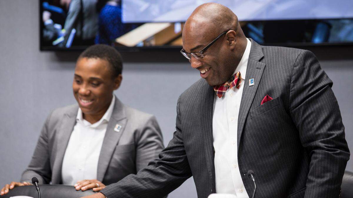 Durham City Council member Vernetta Alston, left, and Council Member Mark-Anthony Middleton, right, await the start of a City Council meeting on Monday, August 6, 2018.