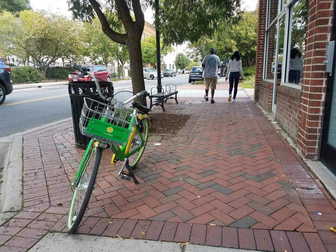 A LimeBike sits on the sidewalk on Parrish Street on Tuesday afternoon, Sept. 11, 2018.