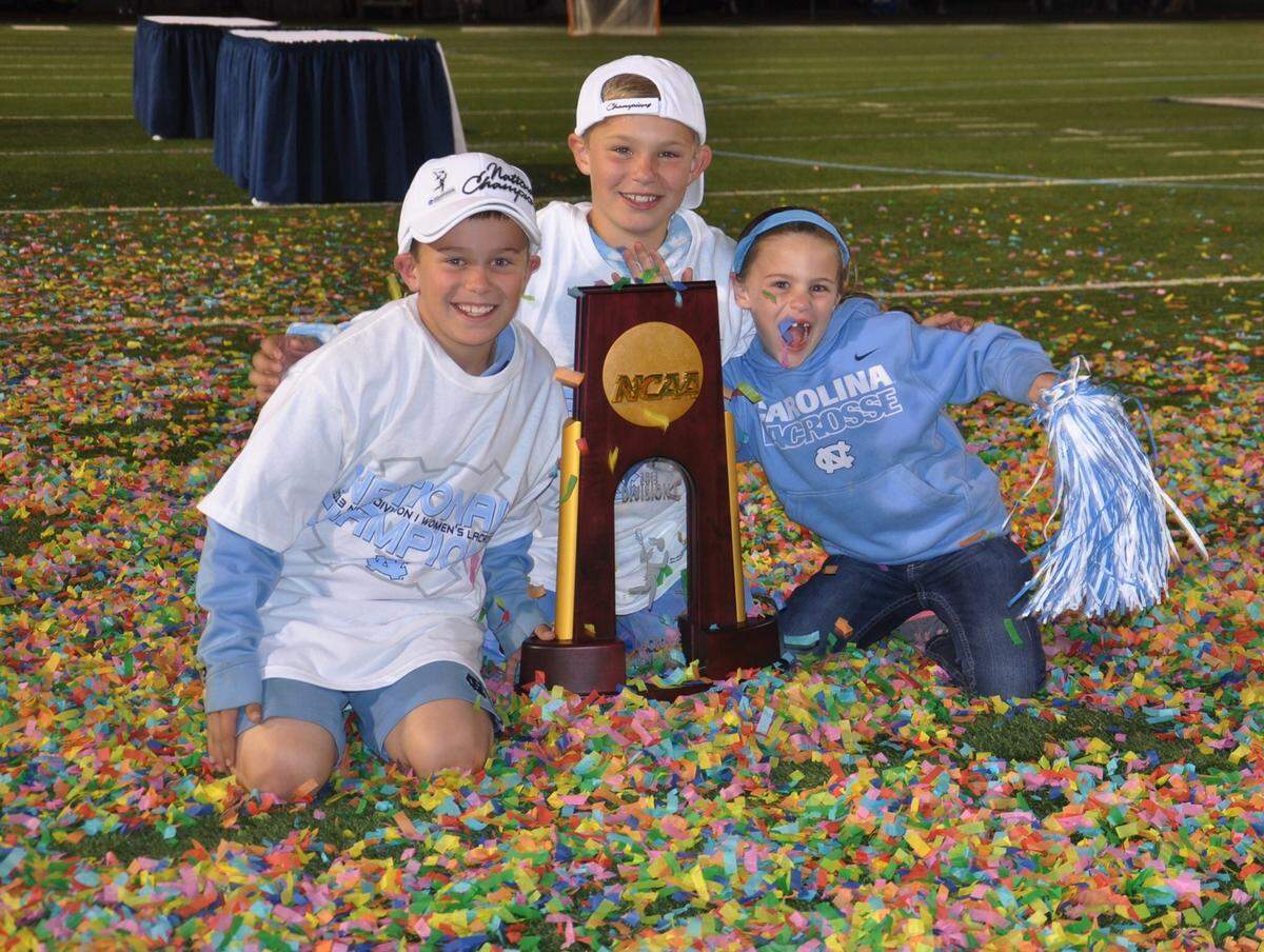 The Levy children celebrate the 2013 national championship win for UNC women’s lacrosse and their mother, head coach Jenny Levy. From left to right: Alec, Ryan, Kate.
