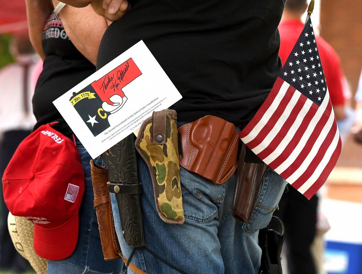 A man wears several gun holsters during a gun-rights rally in Hillsborough, N.C., Saturday, July 21, 2018.