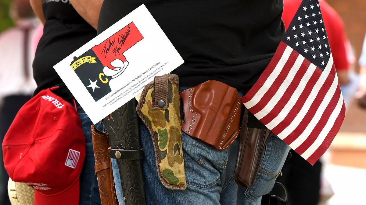 A man wears several gun holsters during a gun-rights rally in Hillsborough, N.C., Saturday, July 21, 2018.
