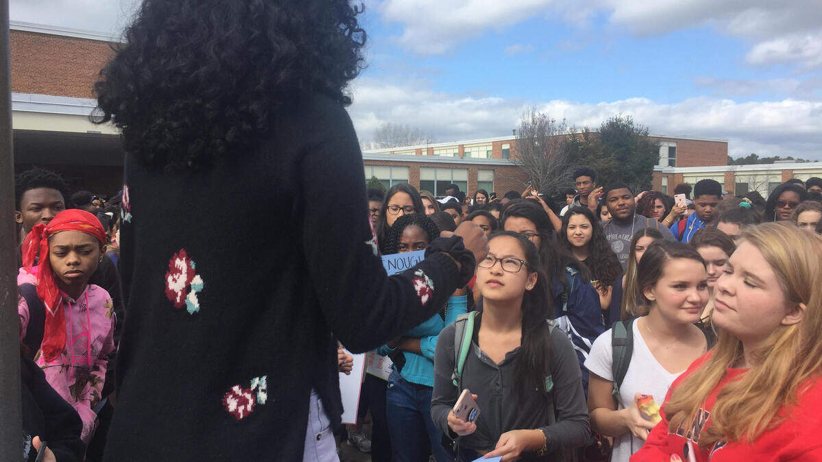 Jordan High School students listen to Aminah Jenkins during a gun-control rally at the school in February. Jenkins is now speaking out against a student-athlete recorded on a video using the N-word and making a sexist remark.