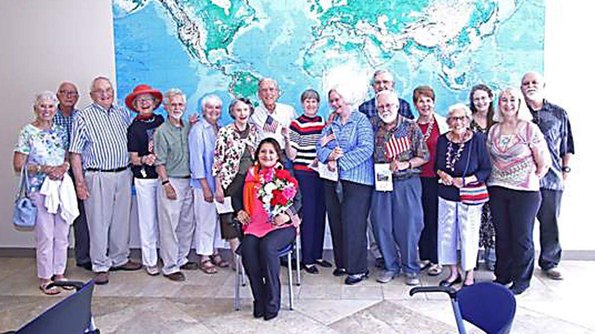 Jennifer Raymundo, a housekeeper at Croasdaile Village retirement community, celebrates her new U.S. citizenship. “We wouldn’t have missed it for the world,” said resident Willard. “She’s brought so much kindness and inspiration into our lives, so it just made sense to be there for her big day.”