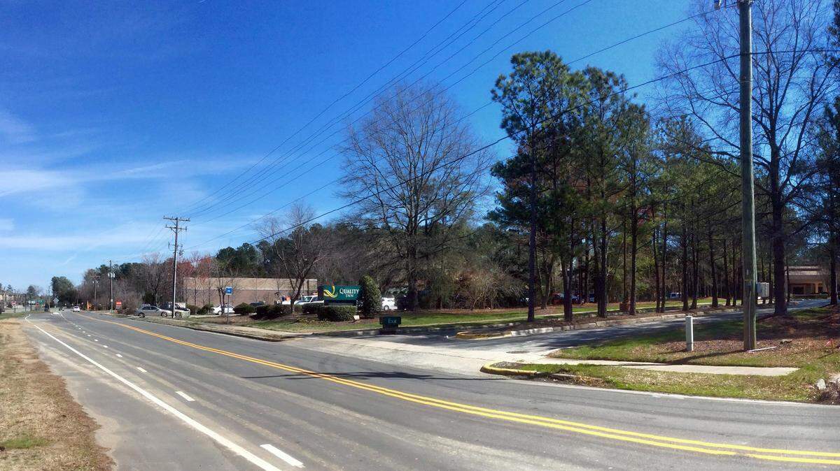 The latest Blue Hill District proposal would replace the Hong Kong restaurant on the Fordham Boulevard service road (center behind the trees) with a 97-room hotel and raze the Quality Inn (right) to make room for a parking garage, apartments, and offices or a second hotel. The site is located near the Europa Drive intersection with Fordham Boulevard, left background, in Chapel Hill.