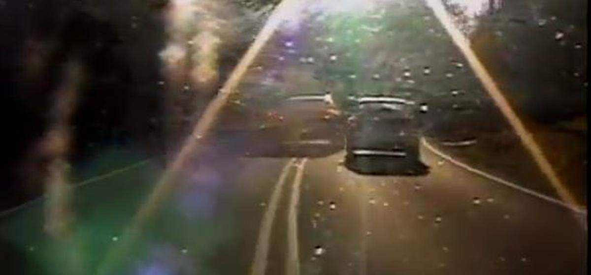 A screen shot from a Durham Police Department dash-camera video that shows Maurice Beckwith passing on a double yellow line on a blind curve on Horton Road as a school bus approaches.