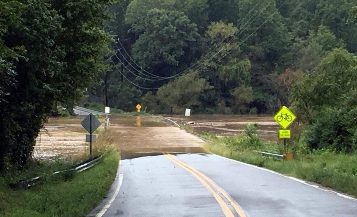 Rain from the remnants of now-Tropical Storm Florence pushed waters over the Jones Ferry Road bridge at University Lake, just west of Carrboro, around 9:20 a.m. Monday.  Jones Ferry Road also was impassable a few miles to the west.