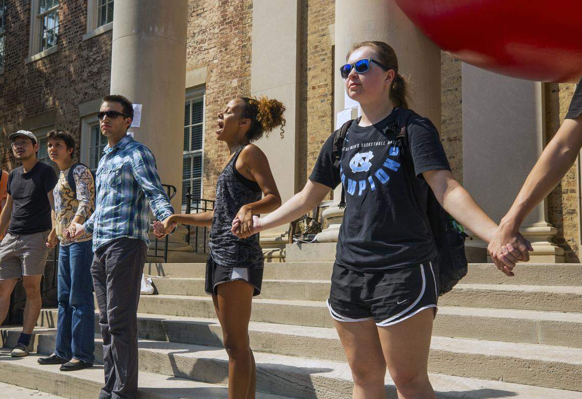 Michelle Brown recites a poem by Assata Shakur with the group that gathered for a rally outside the South Building on Thursday, Sept. 20, 2018, in Chapel Hill, NC. in response to the police violence experienced at recent Silent Sam protests.