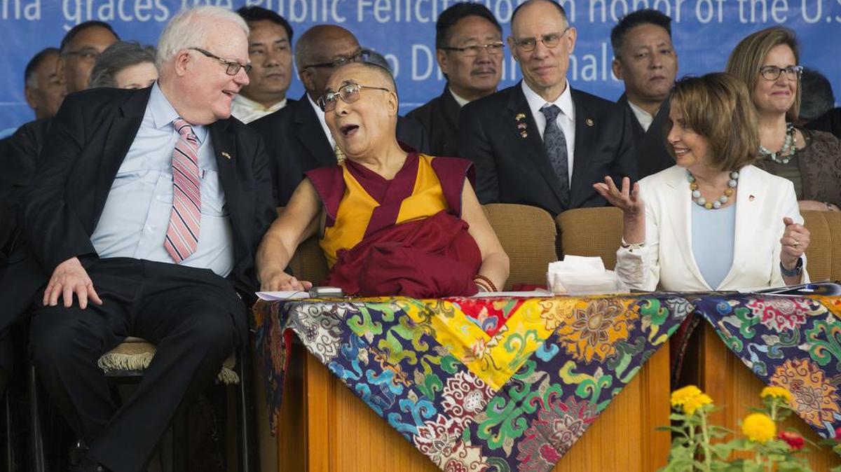 The Tibetan spiritual leader Dalai Lama laughs with Republican Jim Sensenbrenner as the Minority Leader in the U.S. House of Representatives Nancy Pelosi, right, looks on at the Tsuglagkhang temple in Dharmsala, India, Wednesday.